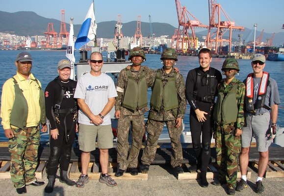 Flanked by members of the Republic of Korea (ROK) Army who served as boat crew for the USACE Forward Rive Team during their October underwater inspection of Pier 8 in Busan are (from left to right) Shanon Chader of Buffalo, Todd Manny of Portland, Kyle Tanner of Nashville and Ed Gawarecki of Buffalo District. 