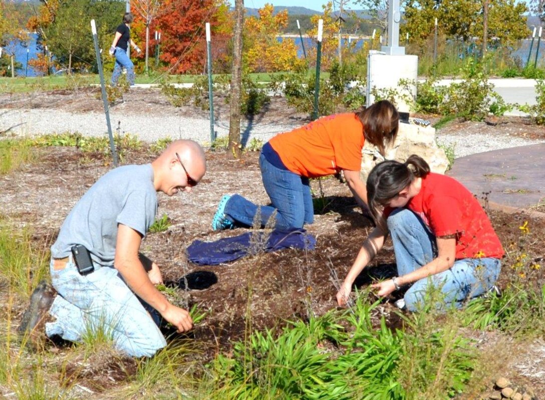 Volunteers work to maintain the grounds of the Dewey Short Visitor Center.