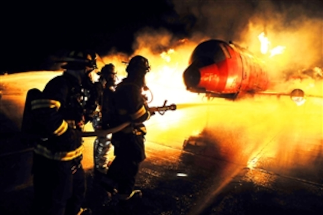 Air Force and civilian firefighters train together to remove simulated victims from a mock aircraft burning at 1,200 degrees on Francis S. Gabreski Air National Guard Base in Westhampton, New York, April 2, 2013. The airmen are assigned to the 106th Civil Engineering Squadron. 