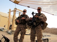 Cpl Brandy Bates (left) and Ensign Iris D. Manso (right) pose for a photo before visiting a Government of the Islamic Republic of Afghanistan school in 2011. Bates and Manso were members of the Female Engagement Team. (Courtesy photo)