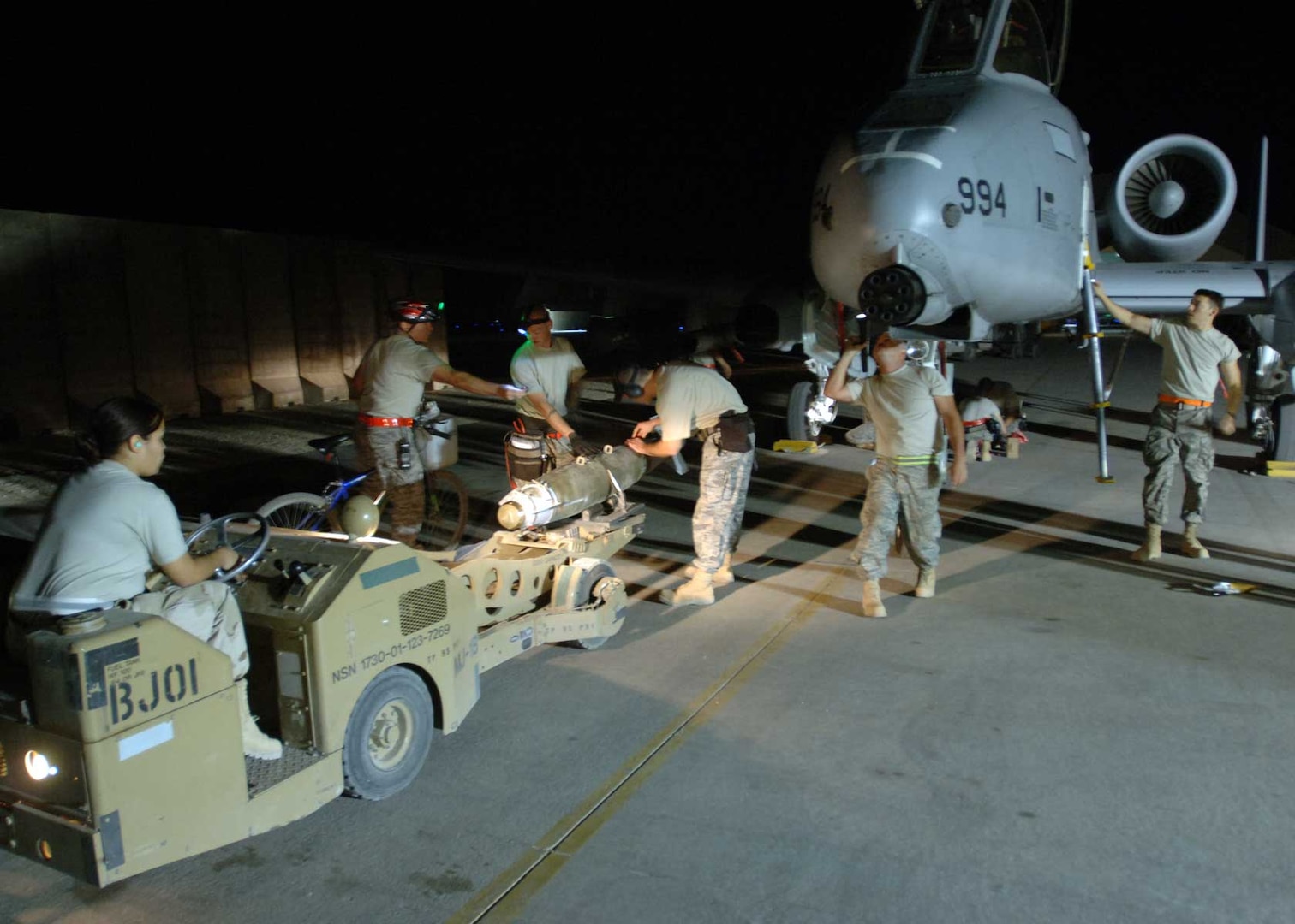 AL ASAD AIR BASE, Iraq -- A 438th Air Expeditionary Group weapons loading team prepares to mount a Joint Direct Attack Munition to an A-10C Thunderbolt II using an MJ-1 â€œjammerâ€ vehicle here. The Airmen made history in Iraq when their upgraded A-10s successfully employed JDAMs in combat. Because the weapon is guided to targets by pinpoint GPS coordinates, experts here say it is 100 percent more accurate than munitions previously employed on the A-10C Thunderbolt II, dramatically improving precision and reducing fratricide. The Airmen are deployed from the 175th Wing, Maryland Air National Guard, located in Baltimore, Md.