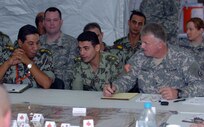 Brig. Gen. Stephen Hines, deputy commander of the Army National Guard's 42nd Infantry Division, confers with Egyptian Brig. Gen. Sala Fouaad, deputy commander of the Egyptian 9th Armored Division. The two organizations will combine staffs to jointly support a battle simulation exercise as part of Bright Star 2007. The training for the U.S. Central Command and U.S. Army Central leaders and staff during Bright Star fosters greater military to military relations with participating nations.