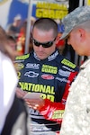 National Guard NASCAR driver, Casey Mears signs an autograph for the Arizona National Guard's 2007 NCO of the Year, Sgt. Frank Ledesma, Nov. 11, during the Checkers Auto Parts 500 at the Phoenix International Raceway.