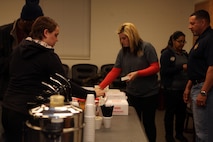 Families, friends and volunteers grab donuts and coffee during a departure ceremony at the 2nd Explosive Ordnance Disposal Company headquarters building aboard Camp Lejeune, N.C., March 28, 2013. The Marines and sailors with 2nd EOD Co., 8th Engineer Support Battalion departed for Afghanistan.