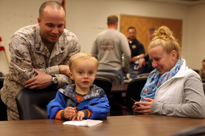 Staff Sgt. Donald J. Baldo III, a technician with 2nd Explosive Ordnance Disposal Company, 8th Engineer Support Battalion, sits with his family during a departure ceremony at the EOD Co. headquarters building aboard Camp Lejeune, N.C., March 28, 2013. Families and friends gathered to bid their loved ones farewell as the Marines and sailors began their journey to Afghanistan that night. 