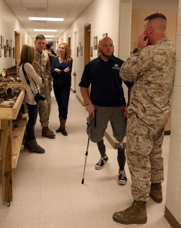 Maj. Eric T. Cline (far right), the 2nd Explosive Ordnance Disposal Company commander, talks to Bradley Lang, a retired staff sergeant and EOD technician, during a departure ceremony aboard Camp Lejeune, N.C., March 28, 2013. Lang and other families and friends attended the ceremony to bid their loved ones farewell as the Marines and sailors of 2nd EOD Co., 8th Engineer Support Battalion began their journey to Afghanistan. 