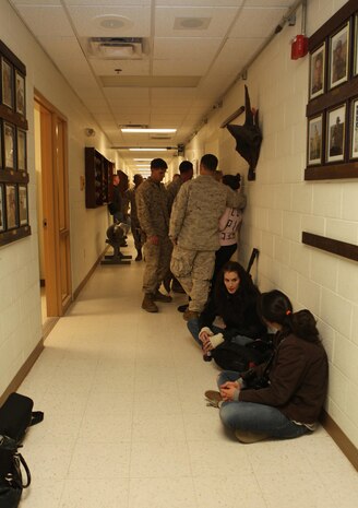 Families, friends and servicemembers line the halls of the 2nd Explosive Ordnance Disposal Company headquarters building during a going-away ceremony aboard Camp Lejeune, N.C., March 28, 2013. The Marines and sailors began their journey to Afghanistan, which should last roughly six months.