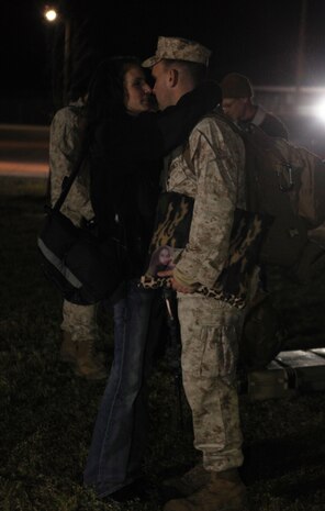 A Marine with 2nd Explosive Ordnance Disposal Company, 8th Engineer Support Battalion hugs his wife one more time before boarding the bus during a departure ceremony aboard Camp Lejeune, N.C., March 28, 2013. Families and friends gathered to bid farewell to their loved ones as they began their journey to Afghanistan. 