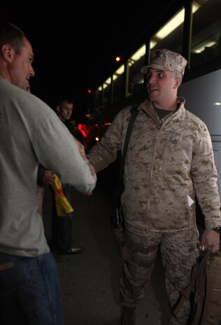 Marines with 2nd Explosive Ordnance Disposal Company, 8th Engineer Support Battalion shake hands with servicemembers as they board the bus during a going-away ceremony aboard Camp Lejeune, N.C., March 28, 2013. EOD technicians who were not deploying attended the ceremony to wish their brothers good luck on their deployment to Afghanistan.