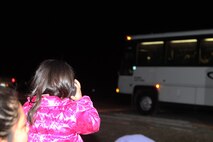 The daughter of a Marine with 8th Engineer Support Battalion talks on the phone to her father, who was on the bus, as the Marines and sailors with 2nd Explosive Ordnance Disposal Company, 8th ESB leave Camp Lejeune, N.C., March 28, 2013. Families and friends gathered to bid farewell to their loved ones as they began their journey to Afghanistan. 