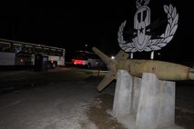 Buses drive past the 2nd Explosive Ordnance Disposal Company emblem, which stands outside of their headquarters building aboard Camp Lejeune, N.C., March 28, 2013. The Marines and sailors with 2nd EOD Co., 8th Engineer Support Battalion and other supporting units boarded the buses and began their deployment to Afghanistan. 
