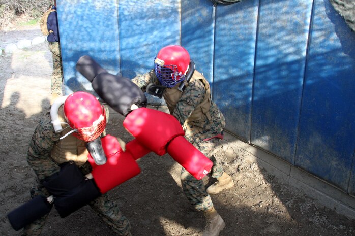Recruits of Company L, 3rd Recruit Training Battalion, engage in pugil sticks competition as part of their Marine Corps Martial Arts Program after the Bayonet Assault Course aboard Marine Corps Recruit Depot San Diego March 19. Recruits must compete against each simulating  hand-to-hand combat.