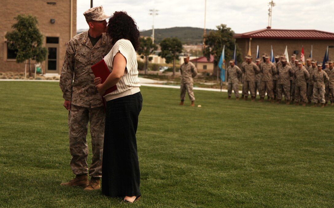 Major Brian P. Chase, the Global Combat Support System Marine Corps Integration Officer with the staff logistics section, 1st 
Marine Logistics Group, shares a kiss with his wife, Amy, during his retirement ceremony aboard Camp Pendleton, Calif., Monday, April 1, 2013. Chase, a native of Portland, Ore., served 23 years in the Marine Corps and plans to retire to the East Coast with his wife and three children.