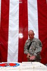 Master Sgt. Clarence Mobley, of the 58th Infantry Brigade Combat Team, cuts the birthday cake during celebrations of the National Guard's 371st birthday at the Al Faw palace at Camp Victory, Iraq, Thursday, Dec. 13, 2007. Mobley, the oldest National Guard servicemember in attendance,has served in both Vietnam as well as the current conflict in Iraq. Celebrations at Camp Victory included representatives from both the oldest National Guard unit as well as the youngest.