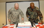 Command Chief Master Sergeant Hardy Pierce (right) and Command Sergeant Major Robert Van Pelt finish cutting the National Guard Birthday cake in the Department of Military and Naval Affairs auditorium in Latham, N.Y. Dec. 13, 2007
