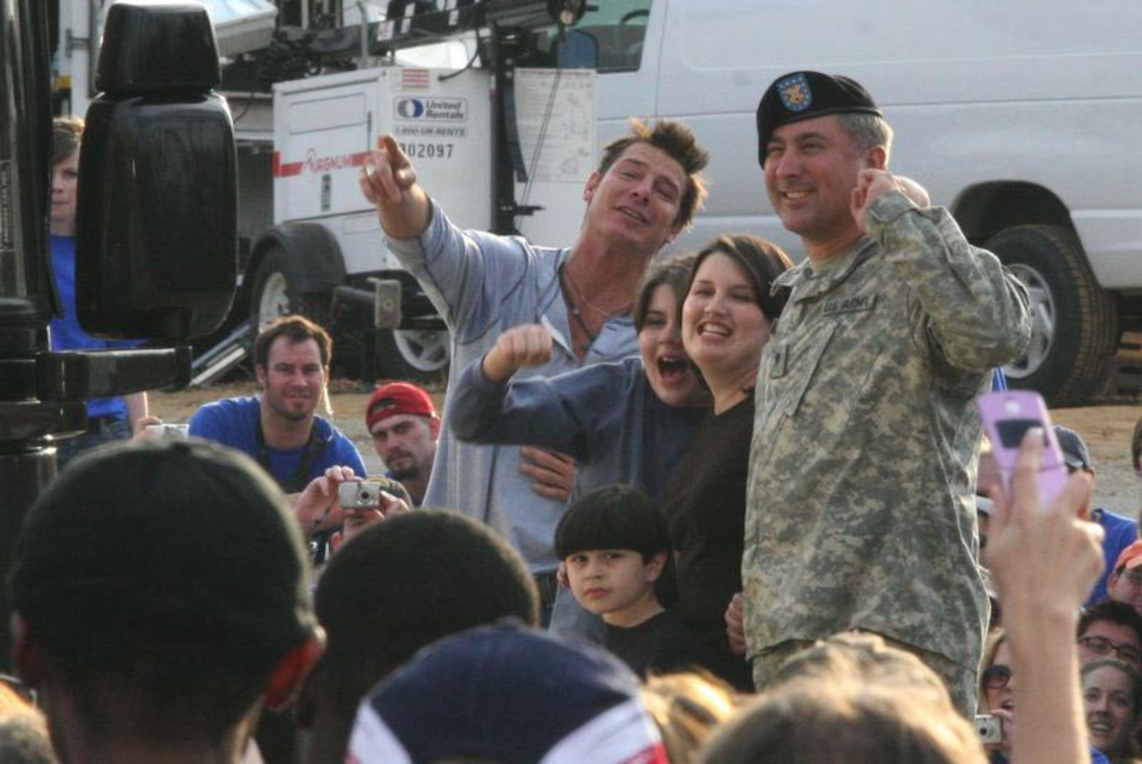 "Extreme Makeover: Home Edition" host Ty Pennington joins the family of Virginia National Guardsman Spc. Michael Lucas in cheering "Move that bus!," allowing the family their first glimpse of their totally-renovated home in Rice, Va., Dec. 10. Lucas is currently deployed to Iraq with Company C, 3rd Battalion, 116th Infantry, Virginia Army National Guard.