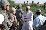 Members of the Missouri Army National Guard's Agri-Business Development Team visit with a local farmer in eastern Afghanistan to discuss how they will assist the farmers in that region in the future.