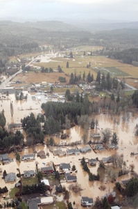 The coastal town of Vernonia, Ore., was hard hit by heavy rains Dec. 2 and 3.  Oregon Governor Theodore Kulongoski reviewed the damage from an Oregon Army National Guard UH-60 Blackhawk helicopter on Dec. 4.