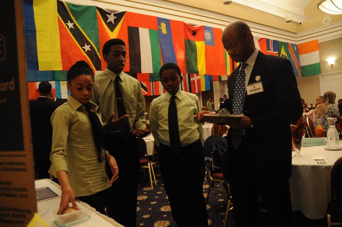Dr. Gerald Weatherspoon, the associate chairman for the department of chemistry and biochemistry at George Mason University, judges one of the four displays assembled by students for the National Society of Black Engineers Jr. first biomedical competition at The Clubs of Quantico on March 13, 2013.