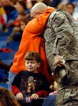 Sgt. Shane Pudgett hugs his wife goodbye as his son, Bryce, age 5, sheds a tear on Monday, Jan. 2, 2008 at the RCA Dome in Indianapolis. This will be the largest Indiana National Guard deployment since World War II, with more than 3,400 Soldiers from about 30 Indiana communities are scheduled to deploy to Iraq for 12-months. The brigade, headquartered in Indianapolis, is commanded by Col. Courtney Carr and Command Sgt. Maj. Gregory Rhoades.