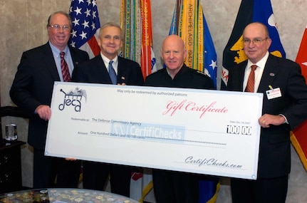 Patrick B. Nixon, president of the American Logistics Association (ALA); Richard S. Page, acting director of the Defense Commissary Agency; LTG H Steven Blum, chief of the National Guard Bureau; and Russ Moffett, chairman of the ALA's consumer awareness team, with an oversize CertifiCheck in Blum's Pentagon office during a Dec. 20 visit to discuss improving Guardmembers' access to commissary benefits.