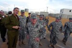 LTG H Steven Blum, chief of the National Guard Bureau (center foreground), and other National Guard leaders and members of the Israeli Defense Forces pause during a Dec. 3, 2007, visit to an Israeli MOUT (military operations on urban terrain) training facility in the Negev Desert, Israel. National Guard officials visited the facility during a four-day trip to Israel to bolster the National Guard Bureau's relationship with that country's Home Front Command and discuss joint exercises and other possible exchanges under the aegis of the U.S. European Command.