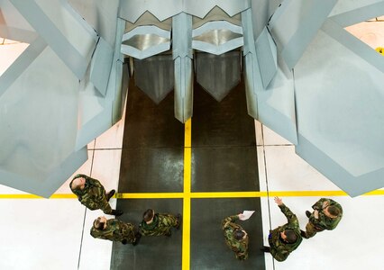 Airmen from the Alaska Air National Guard's 176th Wing at Kulis Air National Guard Base, Alaska, receive training from 477th Aircraft Maintenance Squadron crew chiefs at Elmendorf Air Force Base, Alaska. The Reservists were training the Air Guardsmen on launch and recovery procedures for an F-22 Raptor in case an aircraft might be diverted to the nearby Air Guard base.