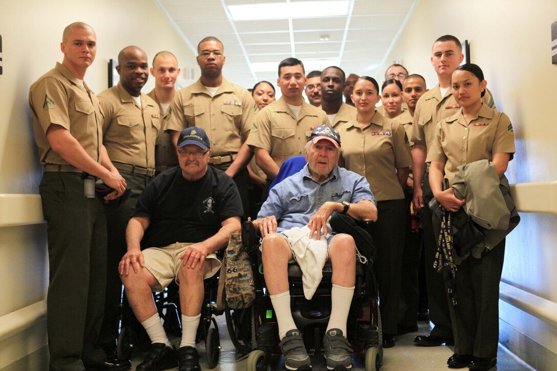 Marines and sailors pose with Moreau and his roommate, Vietnam veteran and former Marine Lance Cpl. Robert Brunson, March 28, 2013. Marines and sailors volunteered to visit the home for the first time in 2011 after hearing that residents felt forgotten by their respective military branches. This is the second group to visit the home and more trips are being planned, said Beverly Boyd, MARFORRES protocol officer and organizer of the trip.