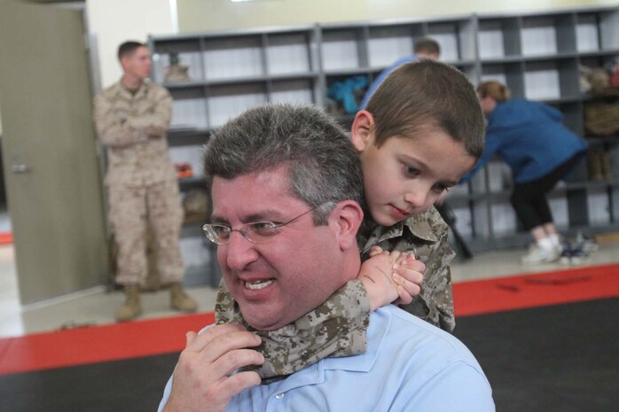 Justin Sekili, an 8-year-old native of Green Oaks, Ill., executes a choke-hold on his father, Aydin Sekili, during a visit to Edson Range here, March 28, 2013. Sekili has a heart defect that required him to undergo multiple open-heart surgeries. The Make-A-Wish Foundation helped Sekili achieve his wish of becoming a Marine for a day. Mr. Sekili said his son wanted to be a Marine since he first saw them on television. (Official Marine Corps photo by Lance Cpl Dabney)