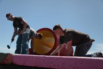 Marines and community members put a fresh coat of paint on playground equipment March 28 in an effort to restore Guam’s green space during Exercise Guahan Shield.  The community members are part of the Islandwide Beautification Task Force and the Noncommunicable Disease Consortium’s Physical Activities Team.  The Marines are part of Guahan Shield, an exercise that will facilitate multiservice engagements, set conditions for bilateral and multilateral training opportunities, and support rapid response to potential theatre crises and contingency operations in the Asia-Pacific region. 