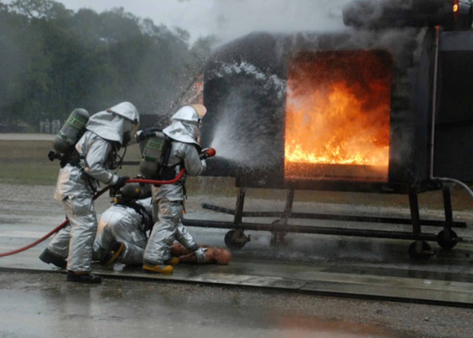 TYNDALL AIR FORCE BASE, Fla. -- Fire fighters from the 176 Civil Engineer Squadron extinguish a simulated aircraft fire during a Silver Flag training exercise here in February.The air guardsmen were part of a 175-man class of engineers and support personnel.