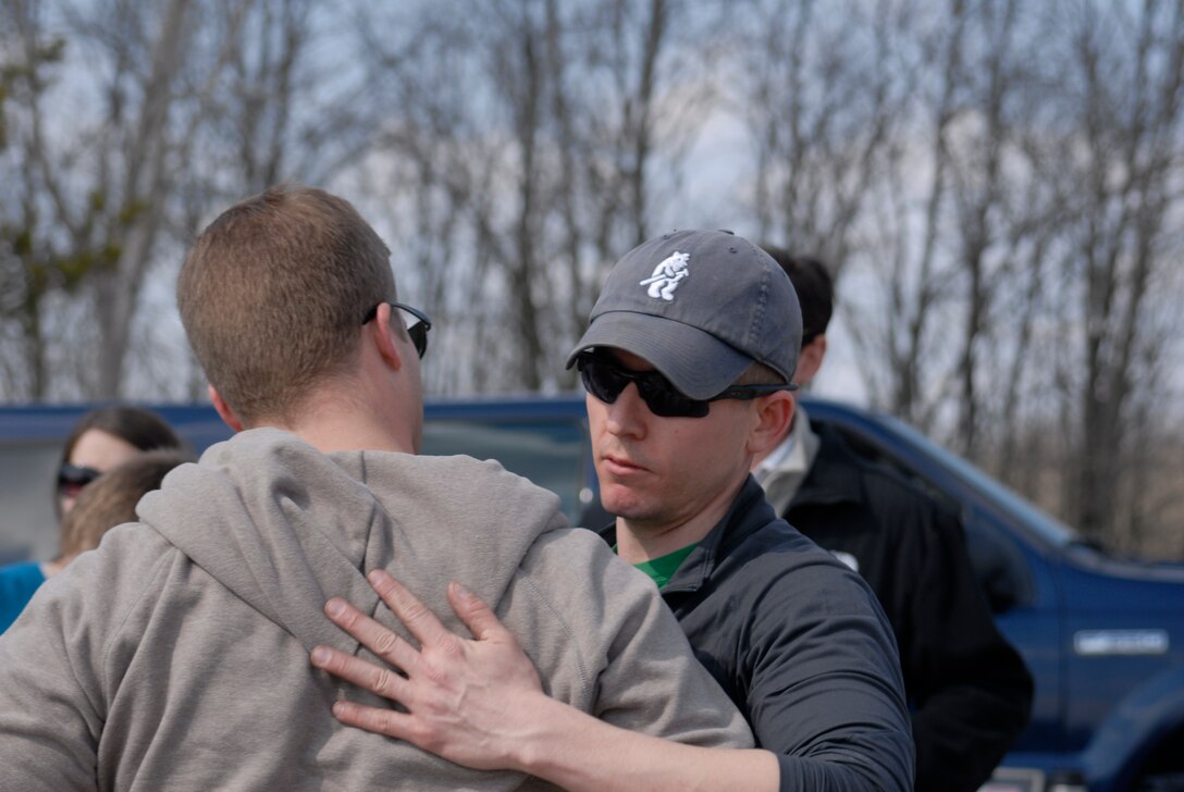 U.S. Air Force Capt. Dan Curtin, right, embraces former Tech. Sgt. Jeb Corley after the Tactical Air Control Party Association 24 Hour Run Challenge at the 182nd Airlift Wing in Peoria, Ill., March 29, 2013.  Both men were deployed to Afghanistan 10 years earlier with fellow Peoria TACP Staff Sgt. Jacob Frazier when he was killed in action.  His and Sgt. Corley’s convoy was ambushed on March 29, 2003, while in route to provide backup to Capt. Curtin’s team during a multi-day firefight with Taliban insurgents near Kandahar.  A decade later, sixty-two supporters ran 161.75 miles around the installation over the course of 24 hours in memory of Sgt. Frazier and raised over $8,200 in support of the TACP community and their families.  (U.S. Air Force photo by Staff Sgt. Lealan Buehrer//Released)