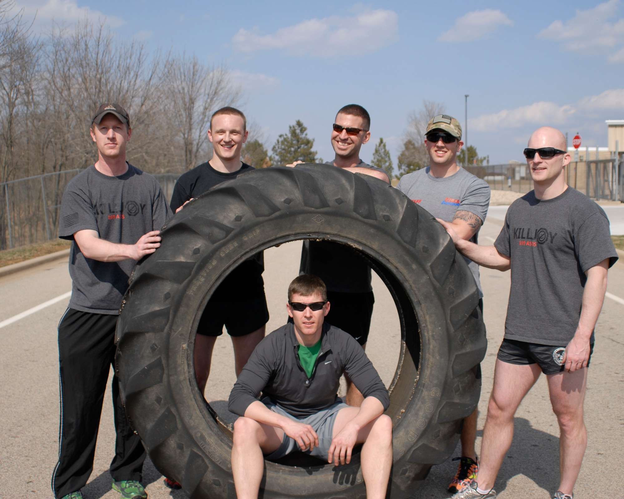 U.S. Air Force Tactical Air Control Party specialists of the 169th Air Support Operations Squadron rest next to a 230 pound tractor tire they flipped across the final lap of the TACP Association 24 Hour Run Challenge at the 182nd Airlift Wing in Peoria, Ill., March 29, 2013.  Sixty-two runners ran 161.75 miles around the installation over the course of 24 hours and raised over $8,200 in support of the TACP community and their families.  The 182nd team also ran in remembrance of Staff Sgt. Jacob Frazier, a member of the Peoria-based 169th Air Support Operations Squadron who was killed in action near Geresk, Afghanistan, exactly 10 years earlier.  (U.S. Air Force photo by Staff Sgt. Lealan Buehrer//Released)