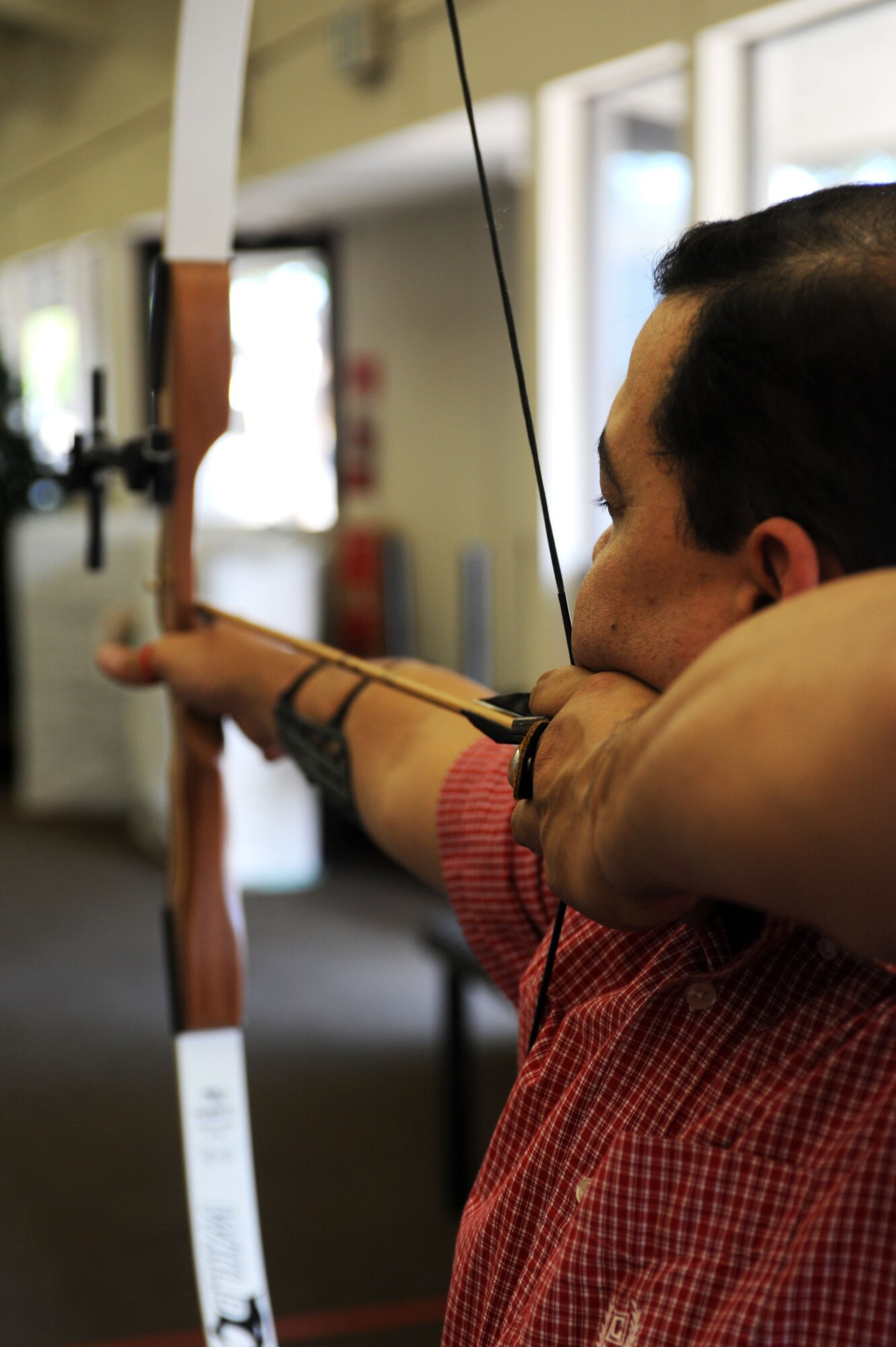 Tech. Sgt. Axel Gaud-Torres aims downrange at an archery range in Marysville Calif., March 29, 2013. He will be competing in the archery category at the upcoming Warrior Games in Colorado Springs, Colo.  (U.S. Air Force photo by Airman 1st Class Bobby Cummings/Released)