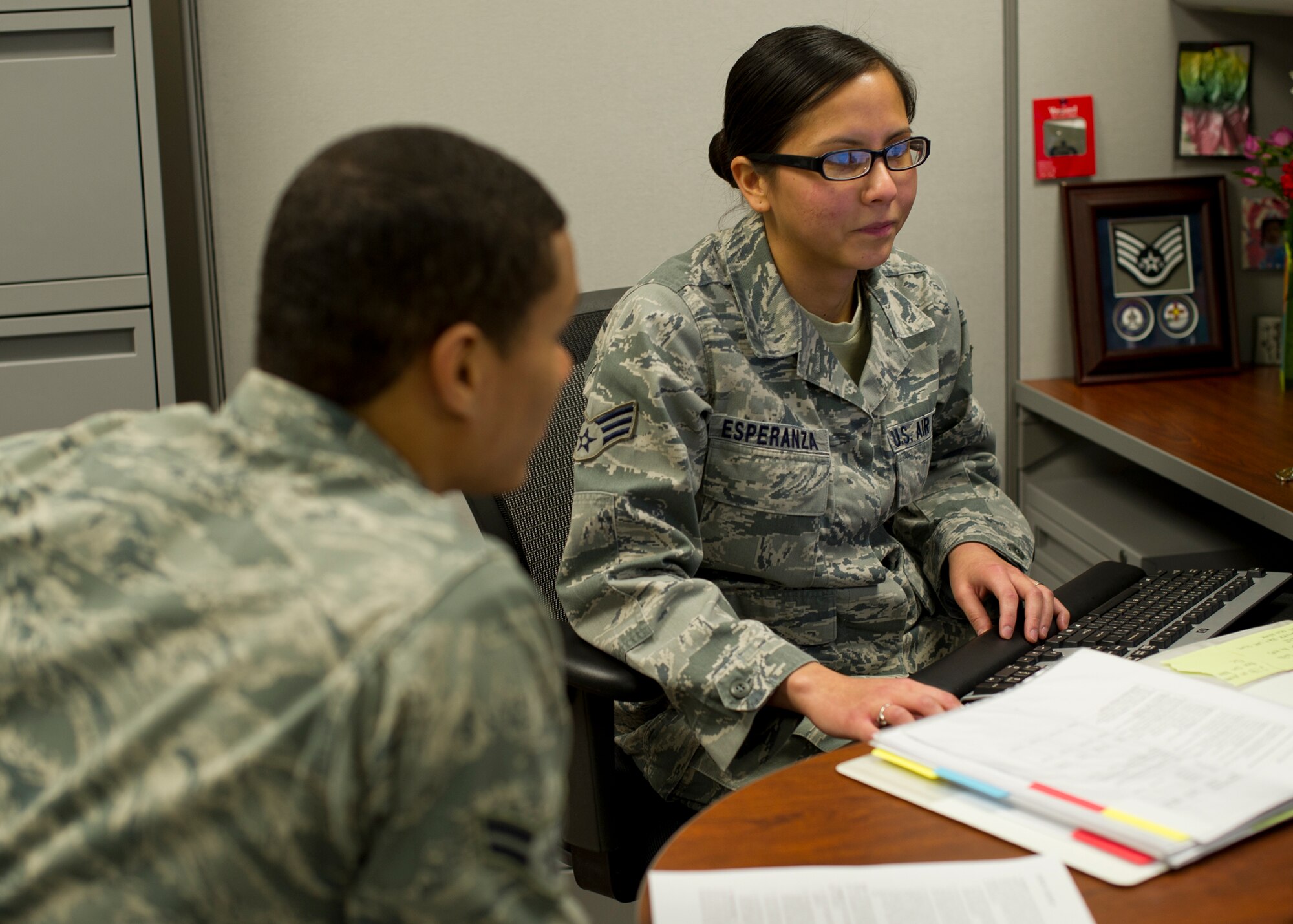 Senior Airman Richelle Esperanza, 49th Force Support Squadron career development supervisor, assists a customer at the Military Personnel Flight at Holloman Air Force Base, N.M., Feb 15. Esperanza works in the career development section as a career development supervisor. She is responsible for managing promotion programs and all of the UIFs for the installation. U.S. Air Force personnel specialists are responsible for advising Airmen on military personnel issues and programs. (U.S. Air Force photo by Senior Airman DeAndre Curtiss/Released) 