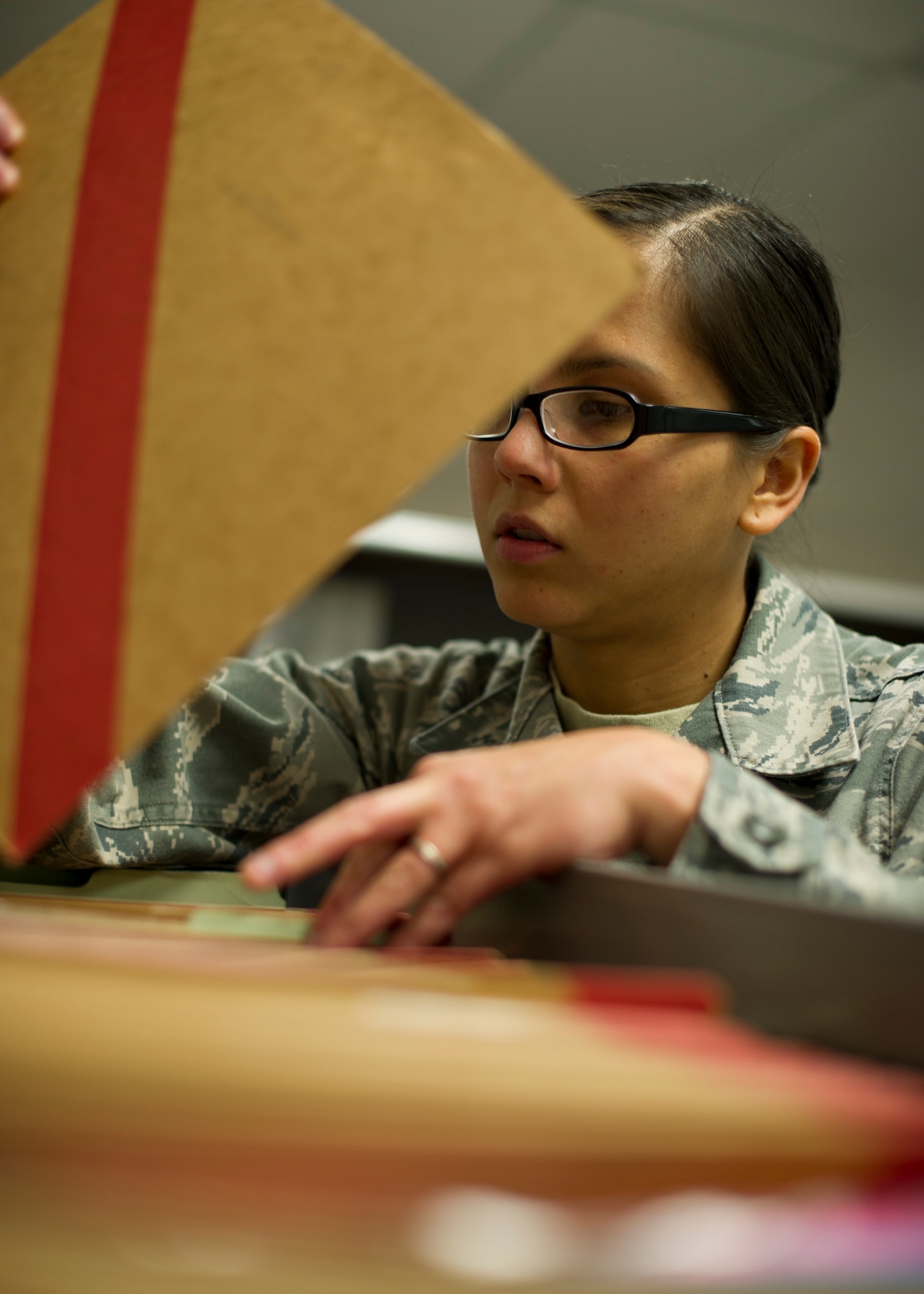 Senior Airman Richelle Esperanza, 49th Force Support Squadron career development supervisor, sorts through the Unfavorable Information Files at the Military Personnel Flight at Holloman Air Force Base, N.M., Feb 15. Esperanza works in the career development section as a career development supervisor. She is responsible for managing promotion programs and all of the UIFs for the installation. U.S. Air Force personnel specialists are responsible for advising Airmen on military personnel issues and programs. (U.S. Air Force photo by Senior Airman DeAndre Curtiss/Released) 