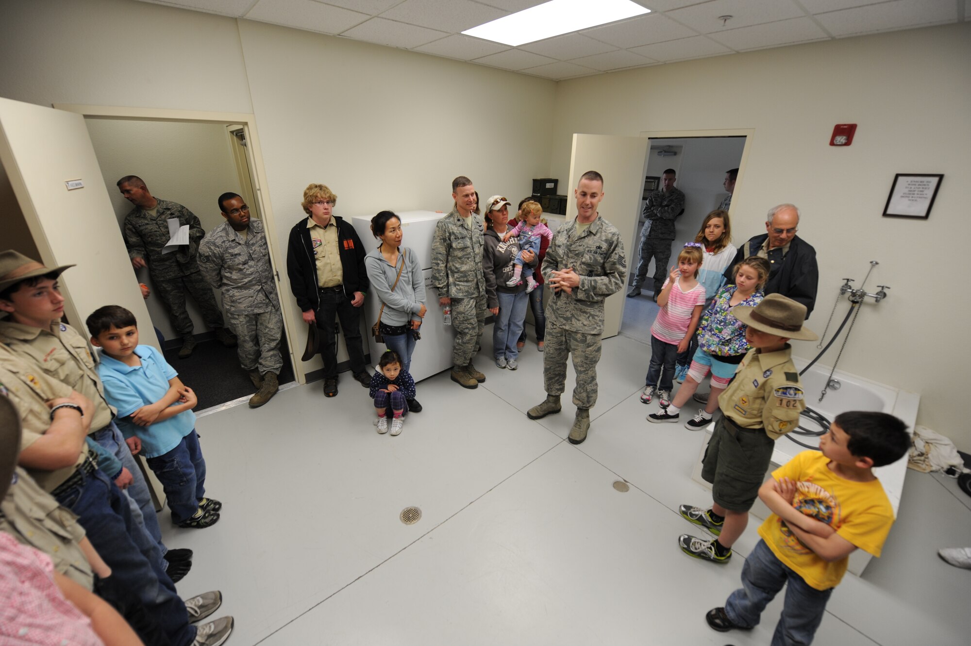 U.S. Air Force Tech. Sgt. Justin Devaney (center), 366th Security Forces Squadron kennel master, gives a tour to Boy Scout Troop 102 in the K-9 veterinary room, at the 366 SFS military working dog kennel at Mountain Home Air Force Base, Idaho, April 1, 2013. Devaney explained how the dogs are treated like professional athletes and given the best care possible. (U.S. Air Force photo/Airman 1st Class Malissa Lott)