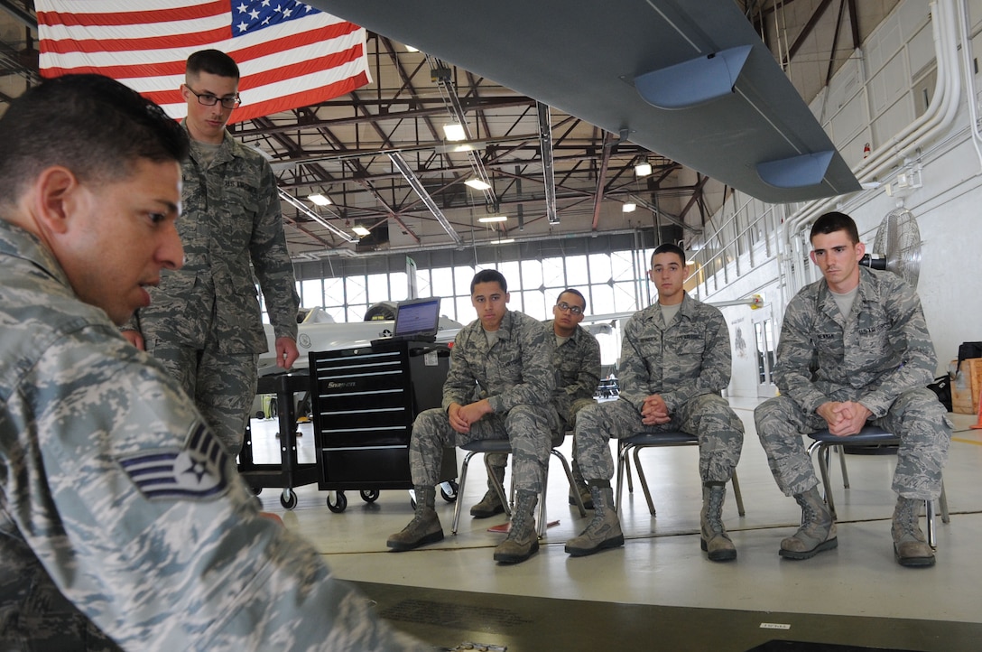 Staff. Sgt. Ronel Rivera-Santiago (left fore), 363rd Training Squadron Aircraft Armament Instructor for the new Remotely Piloted Aircraft armament course, demonstrates how to upload an AGM-114 Hellfire missile to the MQ-9A Reaper during class at Sheppard Air Force Base, Texas, April 4, 2013.  The RPA armament course runs 20 academic days.  (U.S. Air Force photo/Dan Hawkins) 