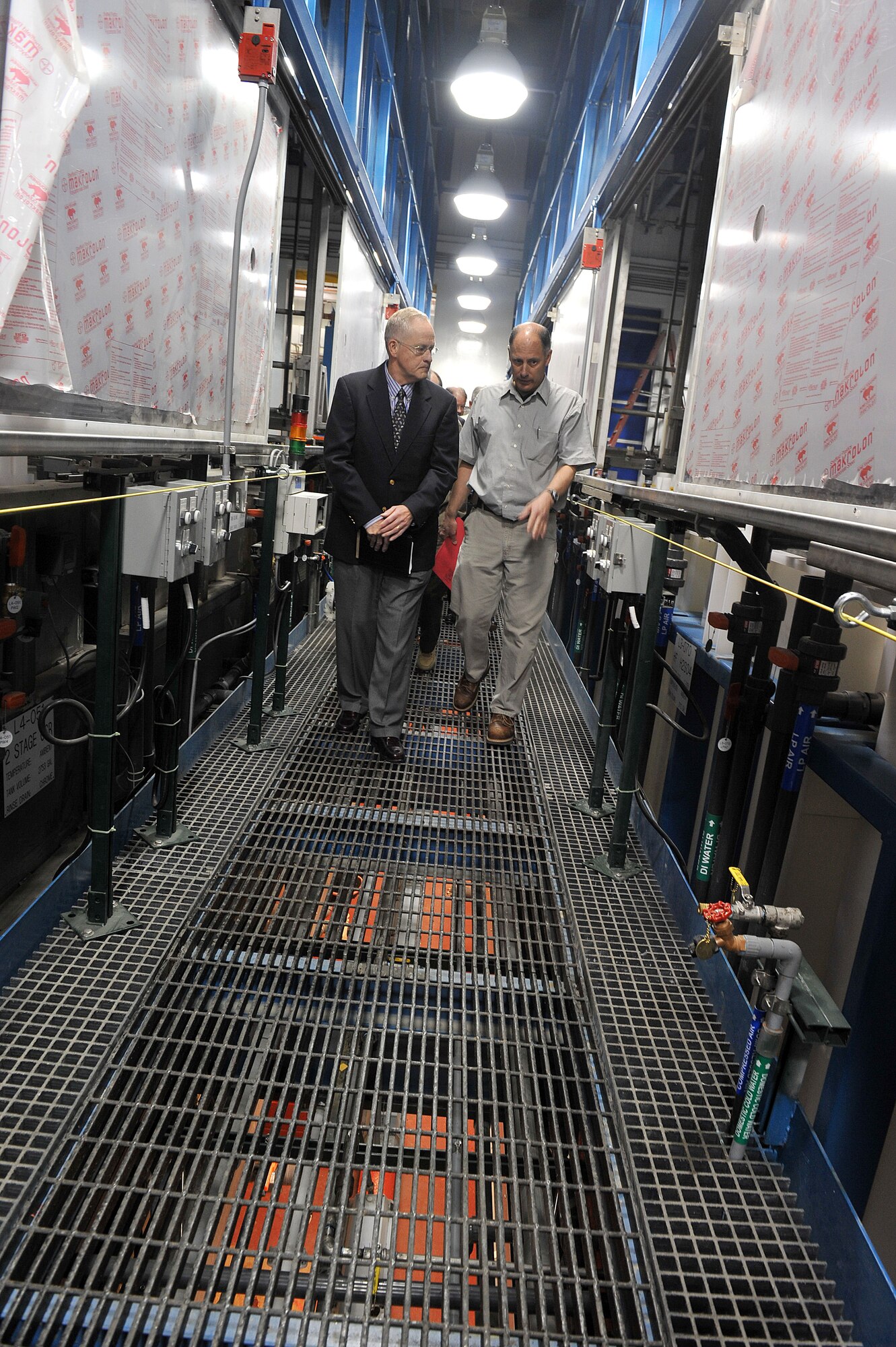 Rretired Lt. Gen. William Hallin, (left) former Warner Robins Air Logistics Center commander; gets a briefing from Jim Cunningham, 402nd Commodities Maintenance Group Process Engineer, during a tour of the Advanced Metal Finishing Facility. (U. S. Air Force photo by Tommie Horton/Released)