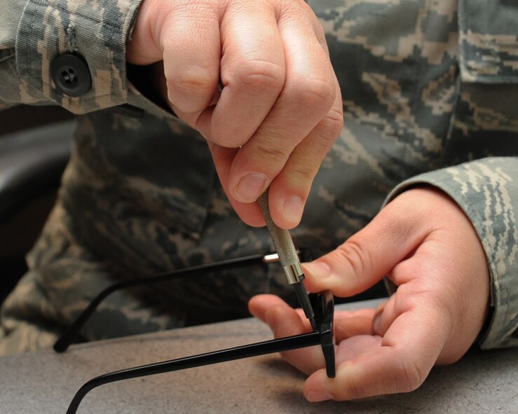 Tech. Sgt. Kelly Carter, 2nd Aerospace Medical Squadron paraoptometric technician, fixes a pair of glasses at the optometry clinic on Barksdale Air Force Base, La., April 4, 2013. Active-duty Airmen who require corrective lenses are allotted one pair of frames per year, which they may choose from a variety of in-regulation frames the clinic has to offer. (U.S. Air Force photo/Senior Airman Sean Martin)
