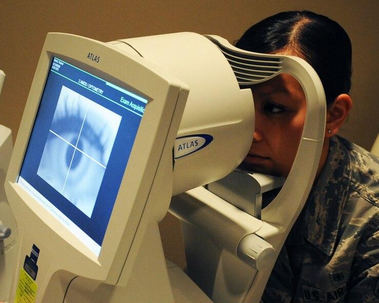 Airman 1st Class Christine Blanco, 2 MDG X-ray technician, has a picture taken of her eye with a topographer on Barksdale Air Force Base, La., April 4, 2013. The topographer takes a photo of the cornea which is used for refractive surgery. (U.S. Air Force photo/Senior Airman Sean Martin)