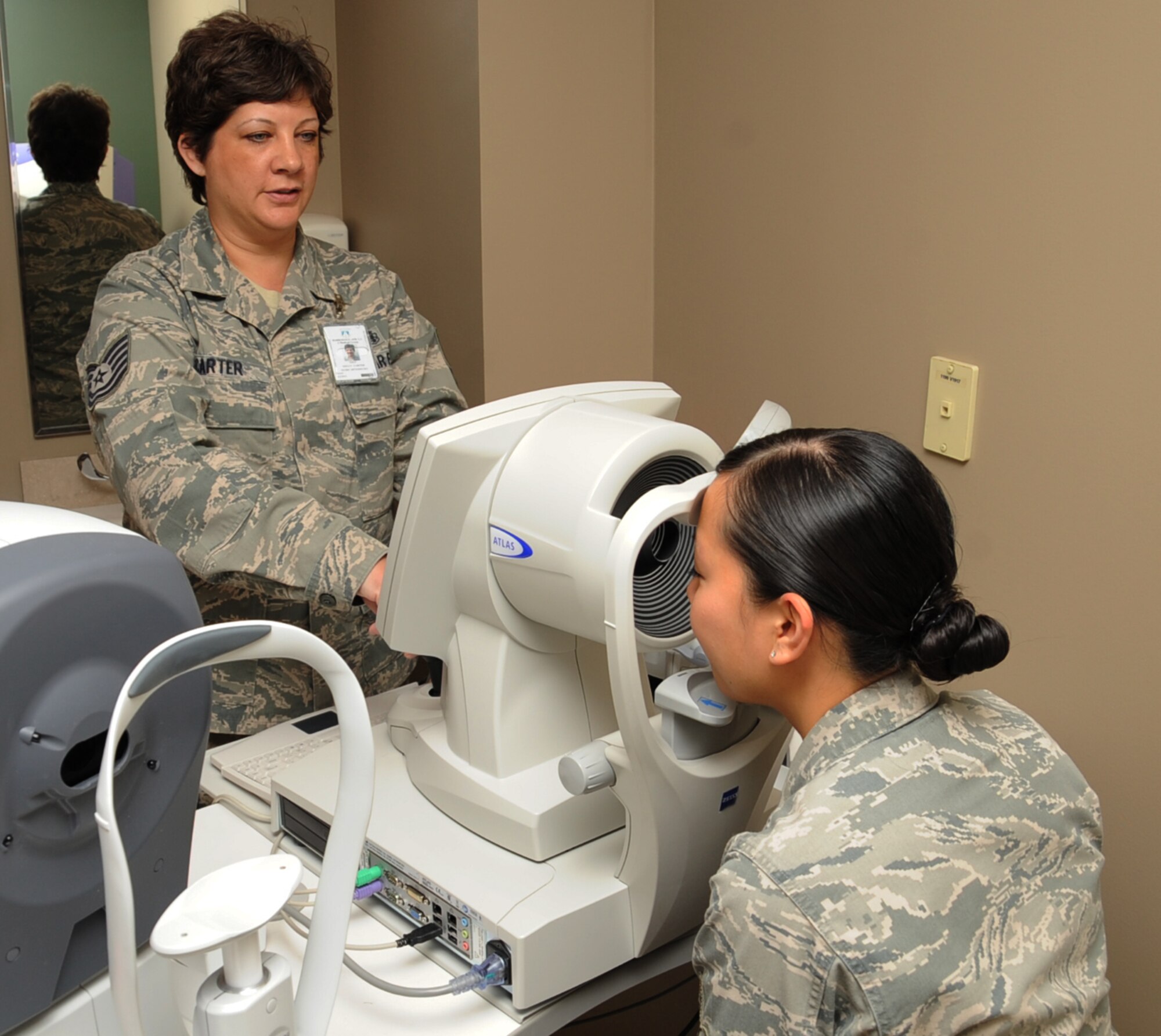 Tech. Sgt. Kelly Carter, 2nd Aerospace Medical Squadron paraoptometric technician, uses a topographer on Airman 1st Class Christine Blanco, 2 MDG X-ray technician, on Barksdale Air Force Base, La., April 4, 2013. The topographer takes a photo of the cornea which is used for refractive surgery. (U.S. Air Force photo/Senior Airman Sean Martin)