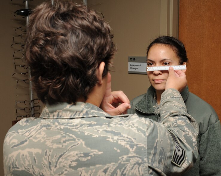 Tech. Sgt. Kelly Carter, 2nd Aerospace Medical Squadron paraoptometric technician, measures the distance between the eyes of 1st Lt. Tiffanie Katz, 2nd Comptroller Squadron financial services flight commander, at the optometry clinic on Barksdale Air Force Base, La., April 4, 2013. The measurement is used to obtain a proper fit for new glasses. (U.S. Air Force photo/Senior Airman Sean Martin)