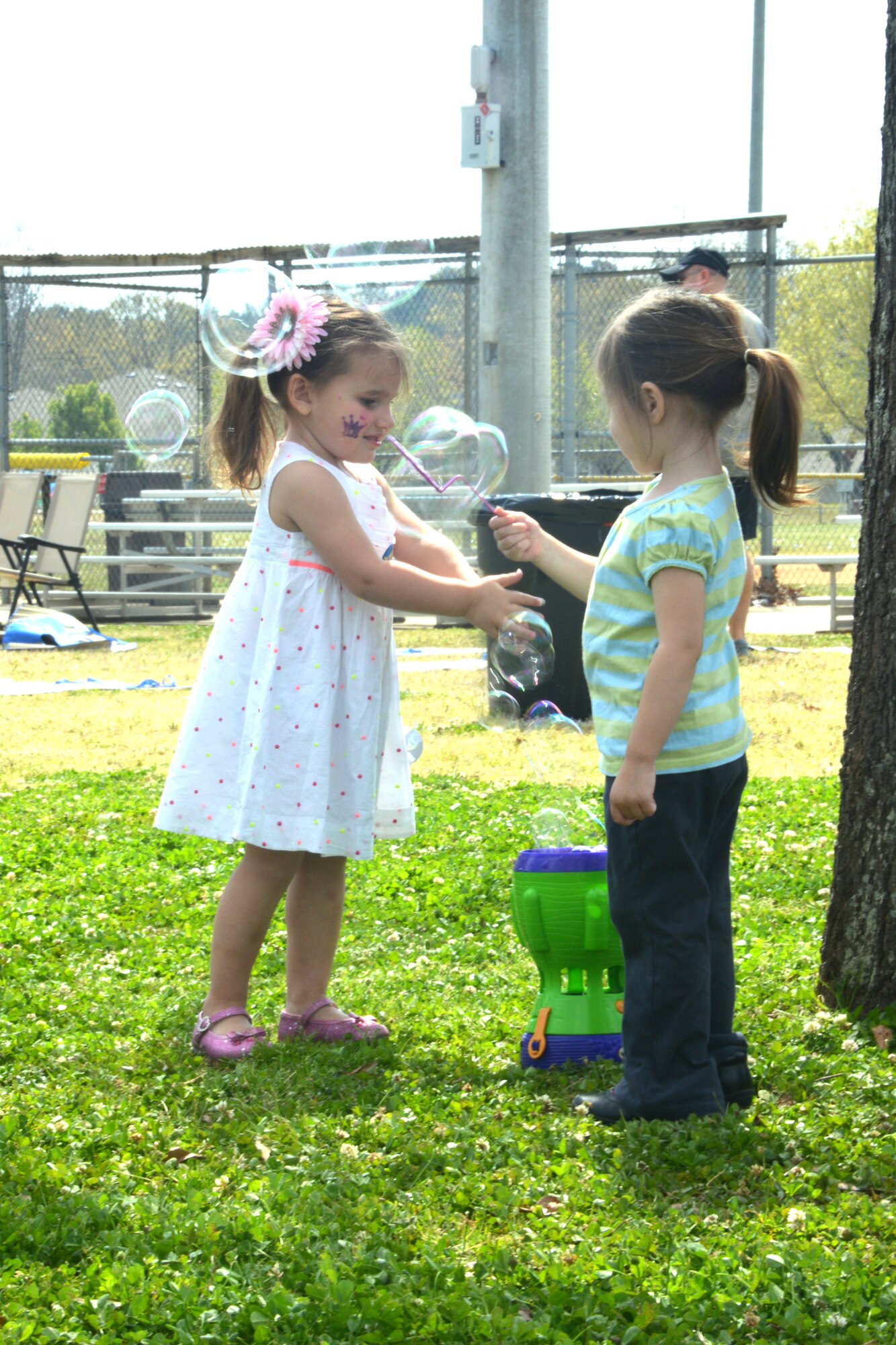 Kayden Maxey (left) and Kaylee Dalman have fun with bubbles. Attendees were also treated to a health and wellness education fair, zumba and face painting. (U.S. Air Force photo by Ed Aspera/Released)