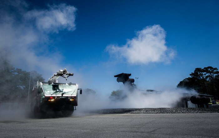 A Striker 3000 fire truck circles a mock plane after spraying water on a fire during an aircraft, live-fire training exercise March 29, 2013, at Joint Base Charleston – Air Base, S.C. The base performs quarterly aircraft, live-fire training for firefighters and crew chiefs to maintain their qualifications. (U.S. Air Force photo/ Senior Airman George Goslin)