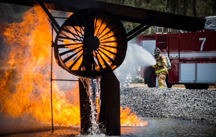 A member from the 628th Civil Engineer Squadron sprays water on a fire during an aircraft, live-fire training exercise March 29, 2013, at Joint Base Charleston – Air Base, S.C. The base performs quarterly aircraft, live-fire training for firefighters and crew chiefs to maintain their qualifications. (U.S. Air Force photo/ Senior Airman George Goslin)