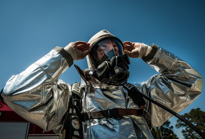 Airman 1st Class Michael Shonebarger, 628th Civil Engineer Squadron firefighter, dons his gas mask during an aircraft, live-fire training exercise March 29, 2013, at Joint Base Charleston – Air Base, S.C. The base performs quarterly aircraft live fire training for firefighters and crew chiefs to maintain their qualifications. (U.S. Air Force photo/ Senior Airman Dennis Sloan)