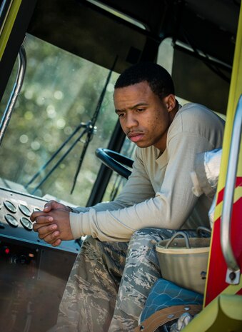 Senior Airman Kirt Wallace, 628th Civil Engineer Squadron firefighter, waits for the water tank on the Striker 3000 fire truck to fill during an aircraft, live-fire training exercise March 29, 2013, at Joint Base Charleston – Air Base, S.C. The base performs quarterly aircraft, live-fire training for firefighters and crew chiefs to maintain their qualifications. (U.S. Air Force photo/ Senior Airman George Goslin)