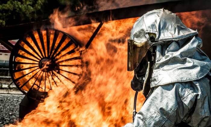 A 628th Civil Engineer Squadron firefighter approaches an inferno during an aircraft, live-fire training exercise March 29, 2013, at Joint Base Charleston – Air Base, S.C. The base performs quarterly aircraft, live-fire training for firefighters and crew chiefs to maintain their qualifications. (U.S. Air Force photo/ Senior Airman Dennis Sloan)