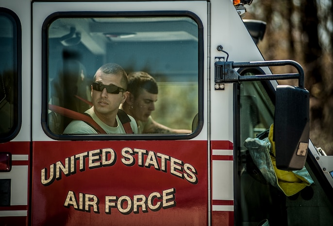 Staff Sgt. Travis Cumpston, 628th Civil Engineer Squadron crew chief, looks out the window of a Striker 3000 fire truck during an aircraft, live-fire training exercise March 29, 2013, at Joint Base Charleston – Air Base, S.C. The base performs quarterly aircraft, live-fire training for firefighters and crew chiefs to maintain their qualifications. (U.S. Air Force photo/ Senior Airman Dennis Sloan))